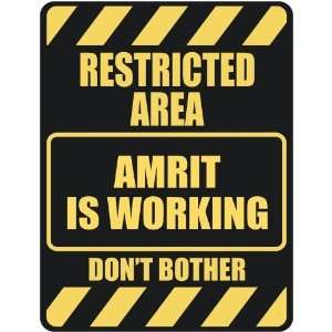   RESTRICTED AREA AMRIT IS WORKING  PARKING SIGN