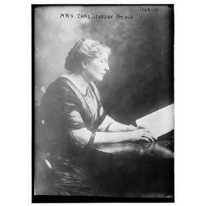   Mrs. Charles Judson Gould at table with book