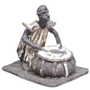   FIGURE A MAN SEATED AT A TENSION TUNED KETTLE DRUM. Toys & Games