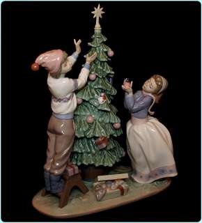   Trimming the tree Figurine #5897, Christmas tree & children figure