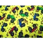 cotton woven sheet features monster trucks on a blue background